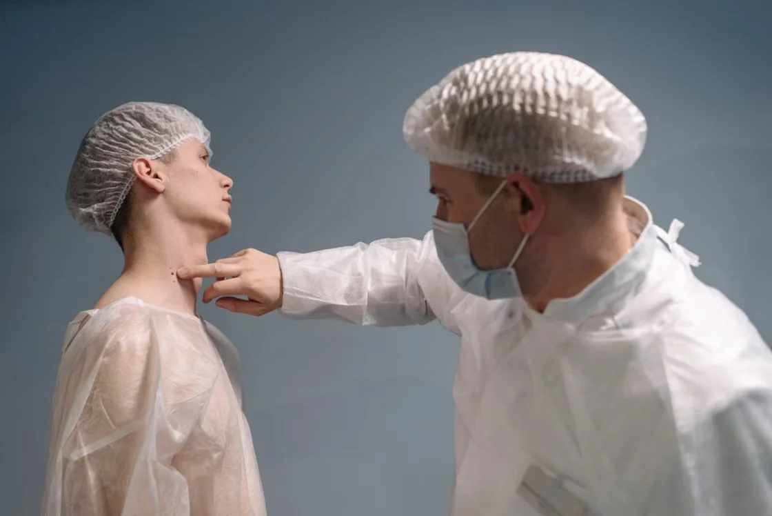 Doctor examining the skin around a patient’s neck