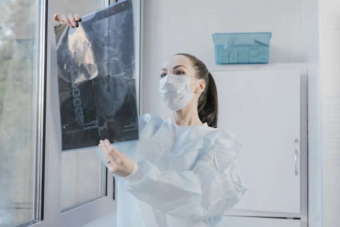 Clinician reviewing a diagnostic X-ray film